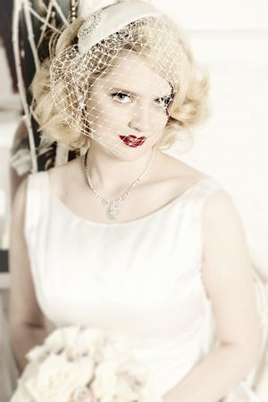 1950s bride with red lipstick and headpiece