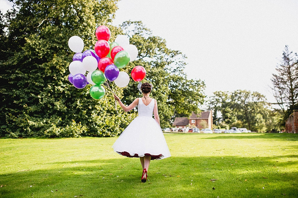 Wizard of Oz inspired wedding, red wedding shoes, colourful wedding, colourful wedding balloons, Candy Anthony, red petticoat, Photography by Ross Harvey